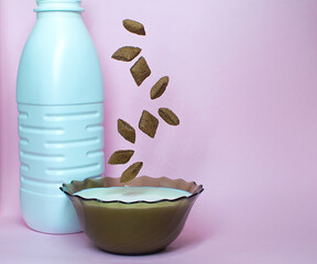 levitate breakfast dried chocolate pads on pink background with milk. Healthy tasty breakfast chocolate square pads.
