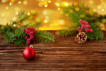 Christmas composition. Christmas tree ball on a wooden background. Blurred background, bokeh lights. selective sharpness
