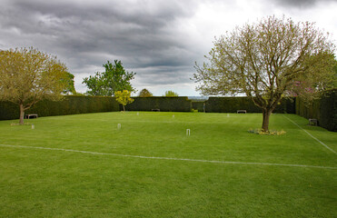 Fototapeta na wymiar Croquet lawn set up ready for a game in an English country garden