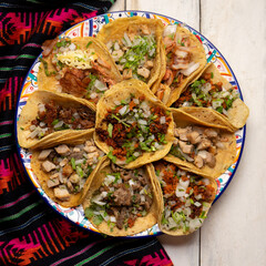 Assortment of mexican tacos on white background
