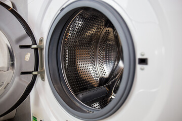 Washing machine, close-up image, drum from the machine is sifting, cleanliness of the machine and clothes