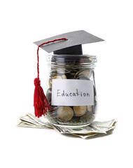 Graduation hat and jar with money on white background. Tuition fees concept