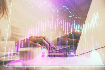 Double exposure of woman hands working on computer and forex graph hologram drawing. Financial analysis concept.