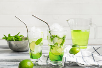 Glasses of fresh mojito on table