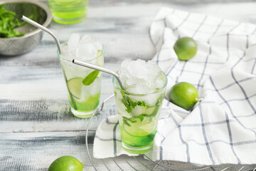 Glasses of fresh mojito on table