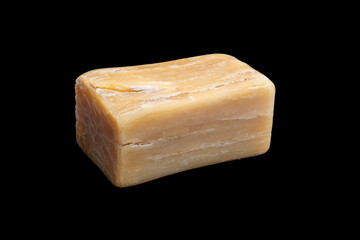 Natural handmade Marseille soap bar isolated on black background.
