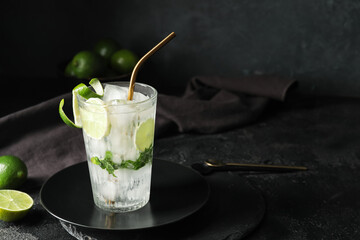 Glass of fresh mojito on table