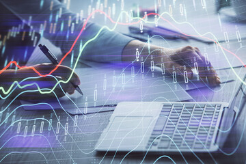 Double exposure of businesswoman hands typing on computer and forex chart hologram drawing. Financial analysis concept.