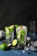 Glasses of fresh mojito on table