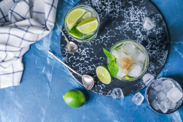 Glasses of fresh mojito on table