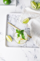 Glass of fresh mojito on table