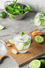 Glass of fresh mojito on table