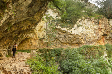 young woman hiking in mountain forest