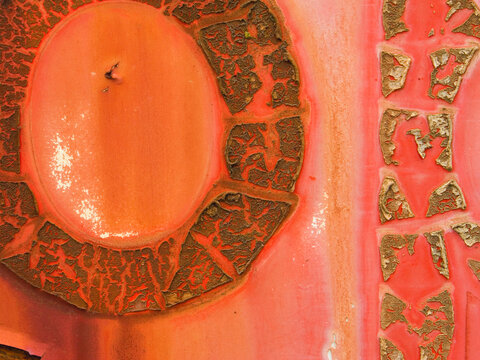 closeup macro of circular bamboo-like textures and colors on decaying decals on an Amtrak train