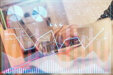 Double exposure of woman hands typing on computer and forex chart hologram drawing. Stock market invest concept.