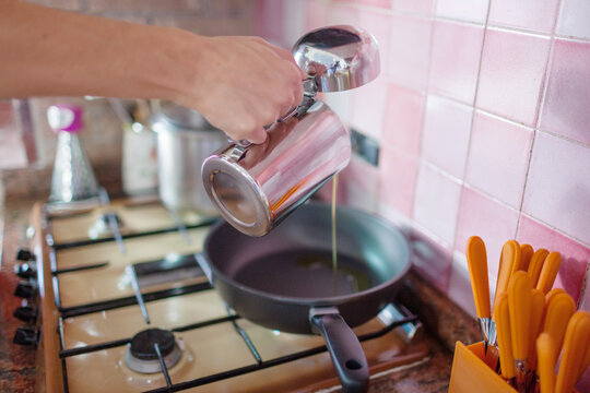 Pouring Olive Oli into a Pan . Cooking