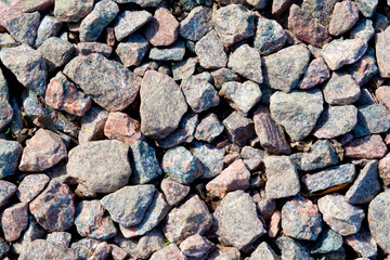 Background of stony pebbles. Small stones of the sea beach
