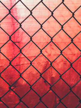 Chain-link fence and red tarp