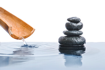 Stack of spa stones in water on white background