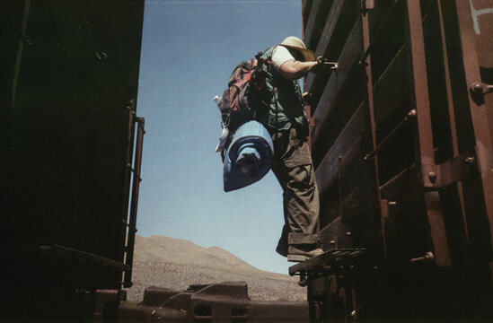 Young Man Climbing on Train