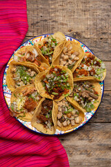Assortment of mexican tacos on wooden background