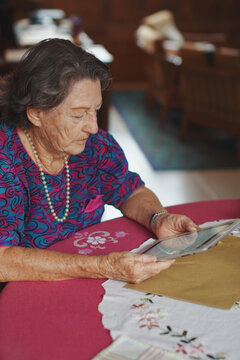 84 year old woman using a tablet in her home