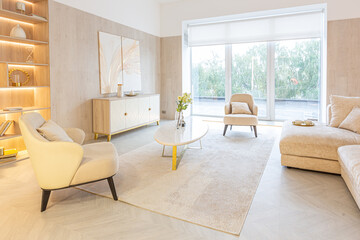 Fototapeta premium modern interior design of the living area in the studio apartment in warm soft colors. decorative built-in lighting and soft beige furniture