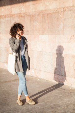 Modern woman having a phone talk.