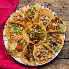 Assortment of mexican tacos on wooden background