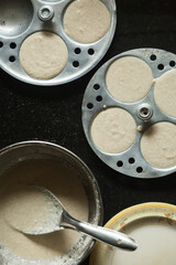 Rice Batter on Idli Maker. Top view of south Indian Dish.