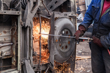 Cutting metal with cutting torch.