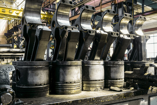Big pistons and connecting rods diesel locomotive engine in a repair depot