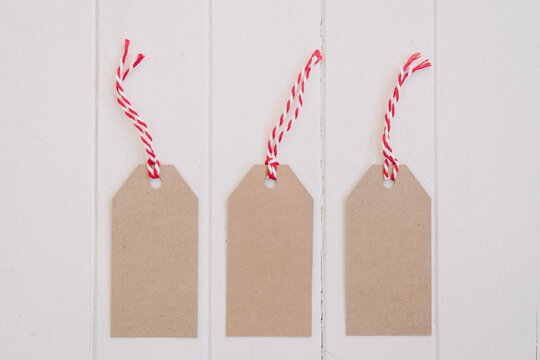 christmas tags in plain cardboard with red string