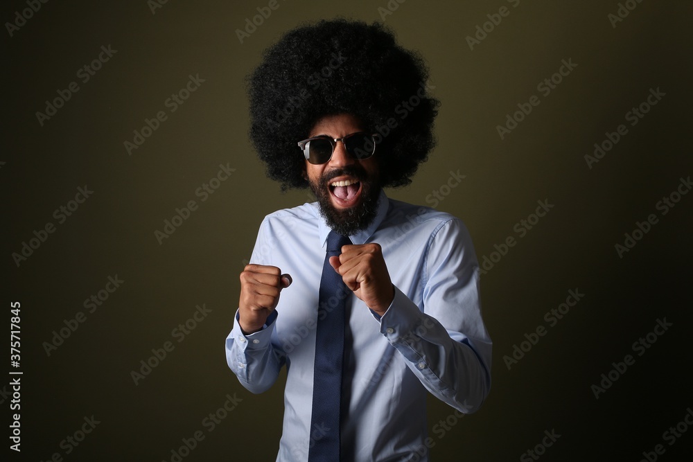 Wall mural beautiful afro man in front of a background