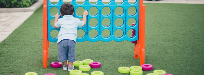 Child playing with a giant board game 