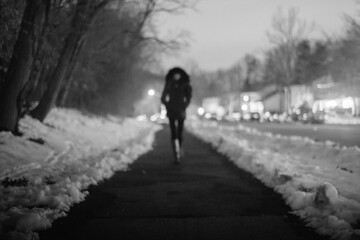 female figure walking on cold winter night