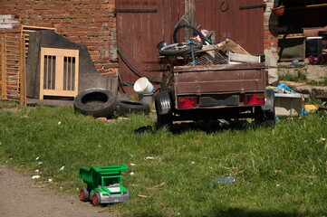 Car trailer loaded with old junk in the backyard.