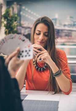Two Young Women Playing Cards