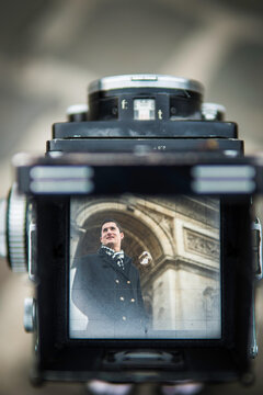 Vintage Film Medium Format Camera Photographing the Man With Arc de Triomphe Paris