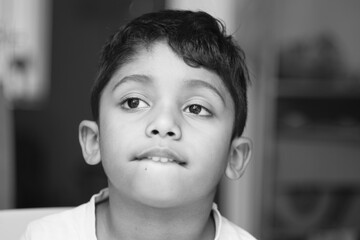 BW portrait of a Teenage young boy lower lip sucking or biting or swallow or placing his upper lip...