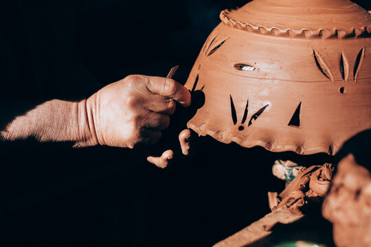Craftsman hands working with clay