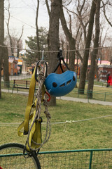 Fototapeta premium A blue safety helmet on the head and a harness hang