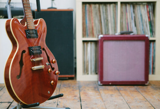 Guitar with amplifier in front of records