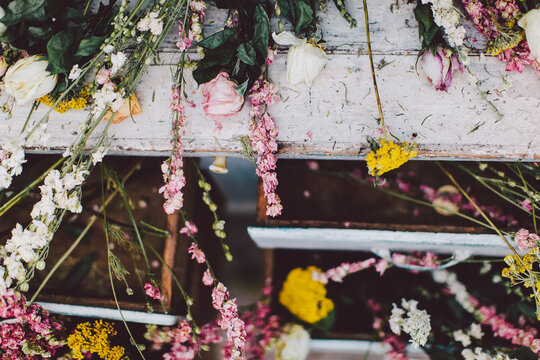 Dried out flowers laying on a white dress
