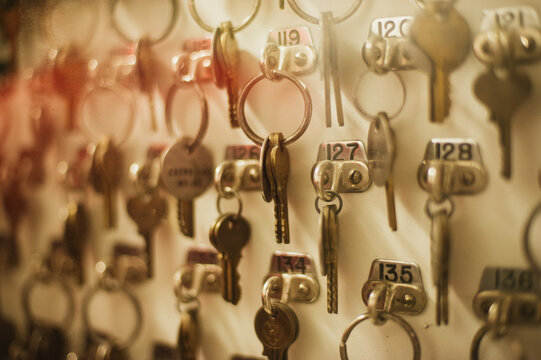 Room keys organized behind locked glass box