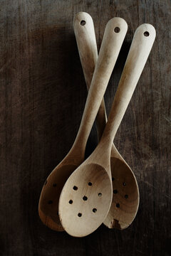 Three wooden spoons on a chopping board