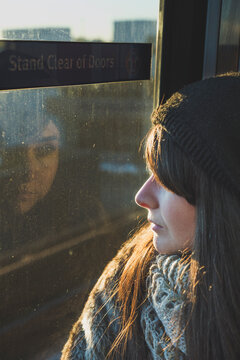 Young woman in a train looking outside