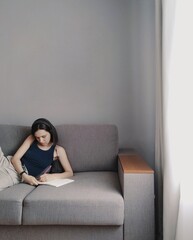 Fototapeta premium young woman sitting on sofa