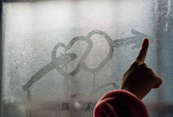 Heart from dew drops on the window surface