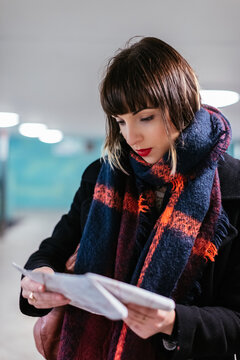 Woman searching the right way on subway train Map. Berlin